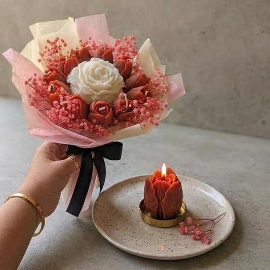 A lit white peach floral bouquet candle burning cleanly on a protective tray, releasing a refreshing fruit-infused aroma into the room