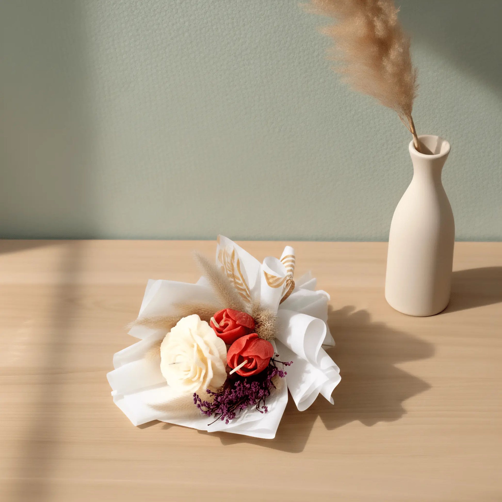 A lit white peony and red tulip floral bouquet candle burning cleanly on a protective tray, releasing a luxurious, rich spring fragrance into the room