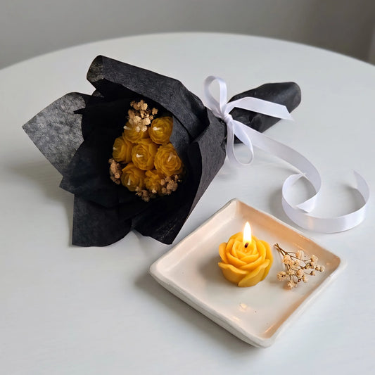 A lit yellow mini floral bouquet candle burning cleanly on a heat-resistant tray, creating a warm, cozy, and refreshing room ambiance