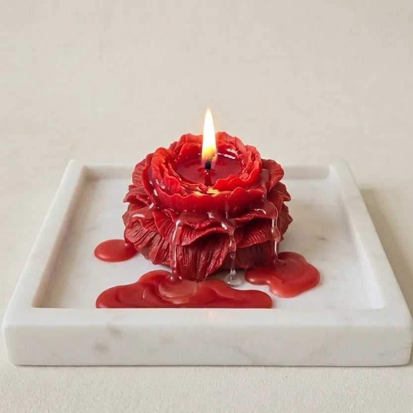 The elegant red peony bouquet candle styled beautifully as a minimal, sober centerpiece on a modern dining table setup for a sophisticated vibe