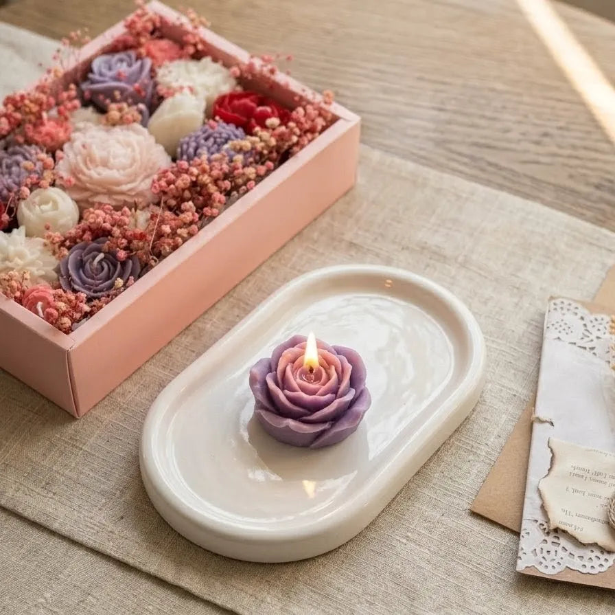 A premium, minimal pink gift box containing a luxury bouquet candle elegantly arranged with real dried flowers